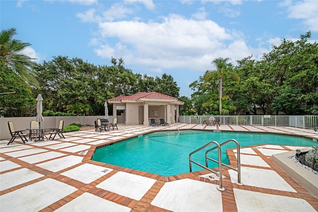 pool featuring a patio area and fence