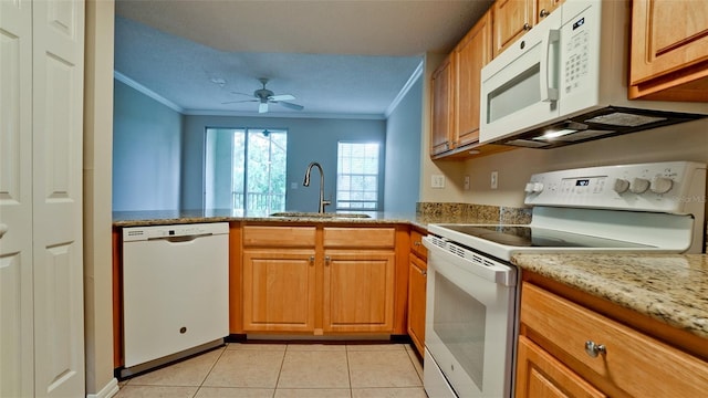 kitchen featuring light tile patterned floors, white appliances, a sink, and crown molding