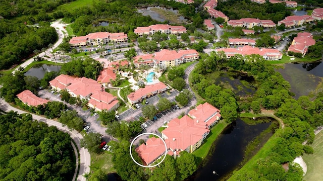 bird's eye view featuring a water view and a residential view