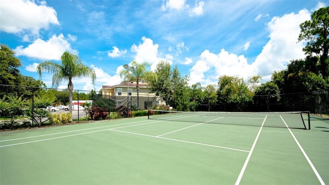 view of tennis court featuring fence