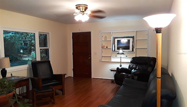 living room featuring hardwood / wood-style floors and ceiling fan