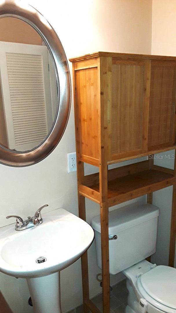 bathroom featuring sink, toilet, and tile patterned flooring