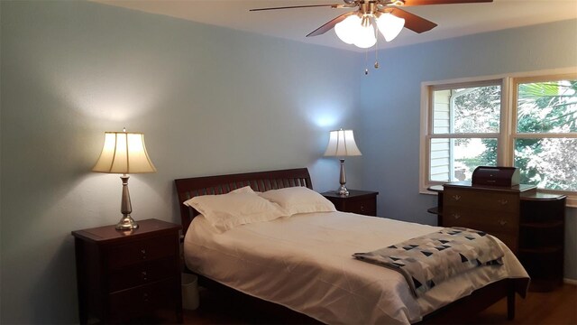 bedroom with wood-type flooring and ceiling fan