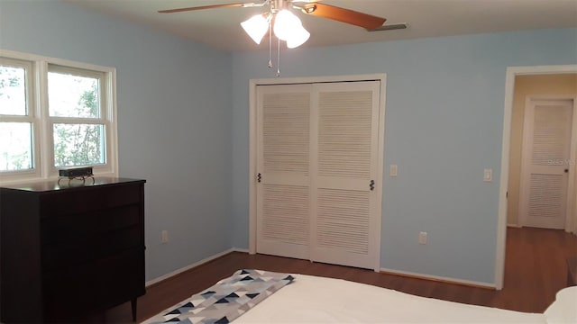 bedroom featuring a closet, ceiling fan, and dark wood-type flooring