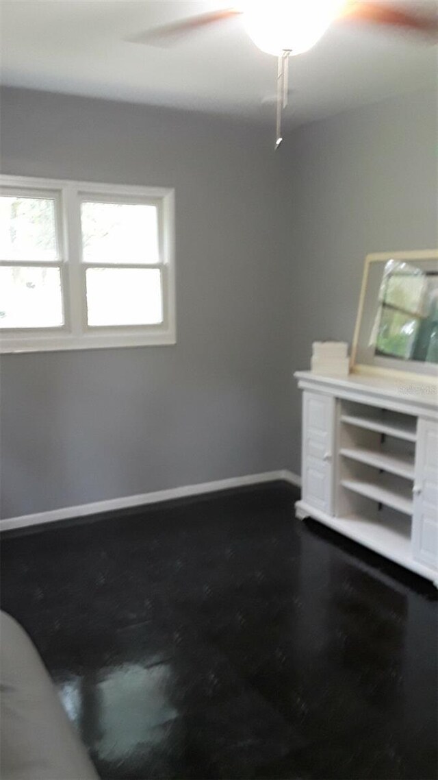 unfurnished living room with ceiling fan