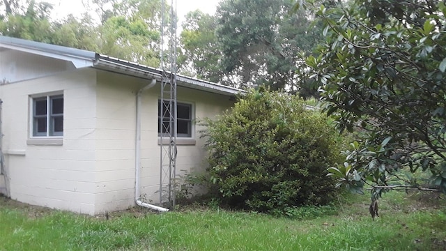 view of side of home featuring concrete block siding