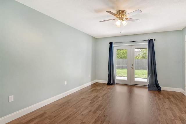 empty room with french doors, ceiling fan, and hardwood / wood-style floors