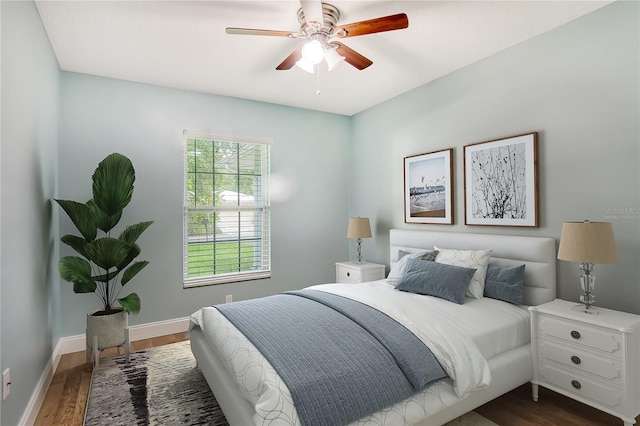 bedroom with ceiling fan and dark hardwood / wood-style floors