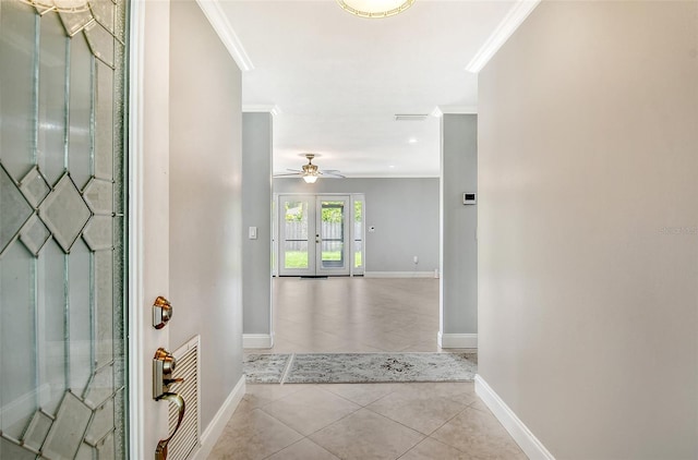 foyer featuring light tile patterned floors, crown molding, and ceiling fan