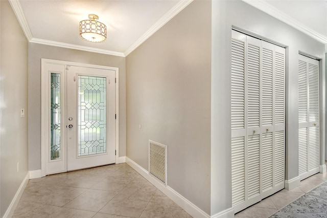 entryway with light tile patterned floors and ornamental molding