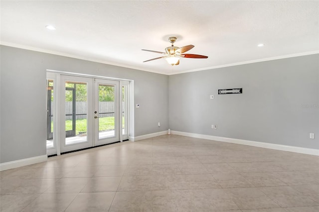 tiled spare room featuring ornamental molding, ceiling fan, and french doors