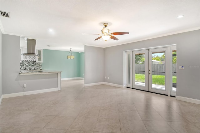 empty room featuring crown molding, light tile patterned floors, ceiling fan, and french doors