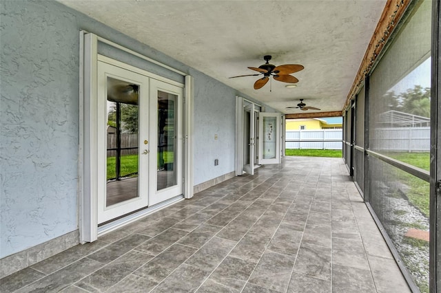 unfurnished sunroom featuring french doors