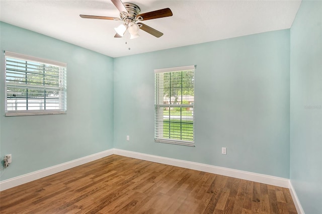 spare room with wood-type flooring and ceiling fan