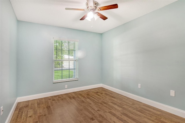 unfurnished room with hardwood / wood-style flooring and ceiling fan