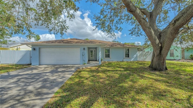 single story home featuring a garage and a front lawn