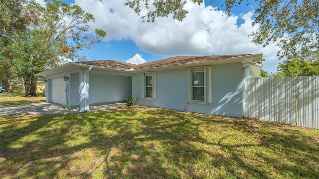 exterior space featuring a garage and a front lawn