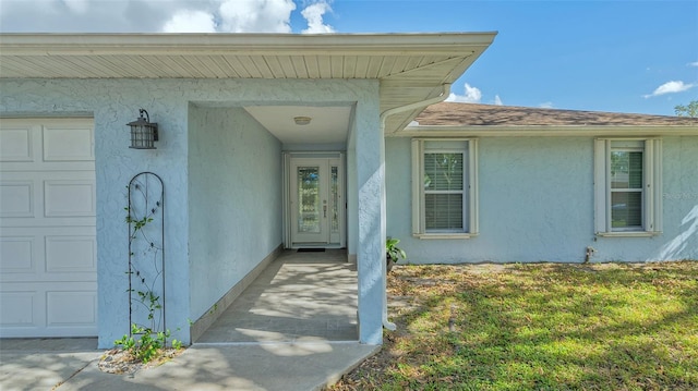 doorway to property with a garage