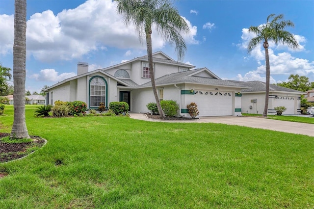 view of front of property featuring a garage and a front lawn