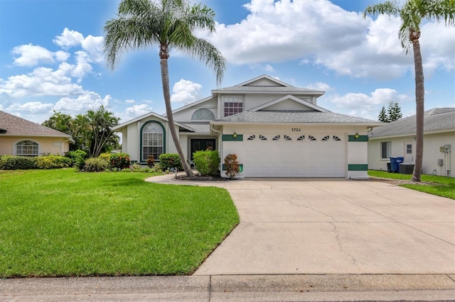 view of front of home with a garage and a front yard