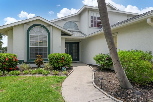 entrance to property with a lawn