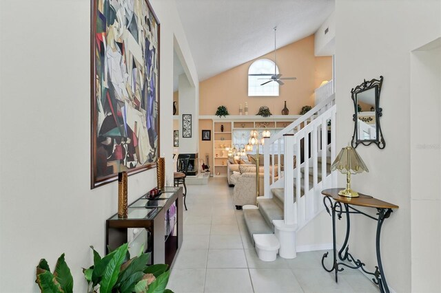 hall with tile patterned floors and high vaulted ceiling