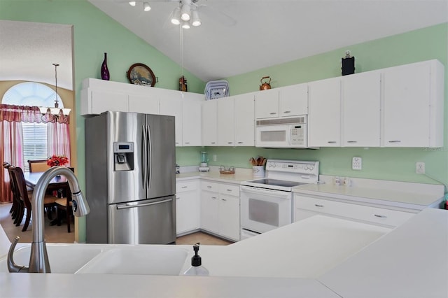 kitchen with white cabinets, ceiling fan, vaulted ceiling, and white appliances