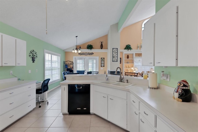 kitchen featuring black dishwasher, sink, pendant lighting, lofted ceiling, and white cabinetry