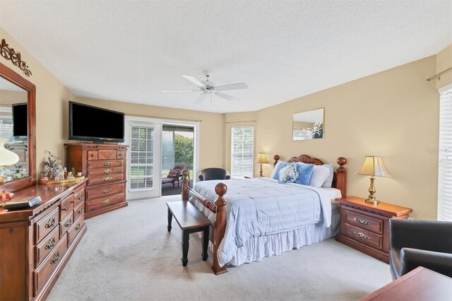 carpeted bedroom featuring a textured ceiling, ceiling fan, and access to exterior