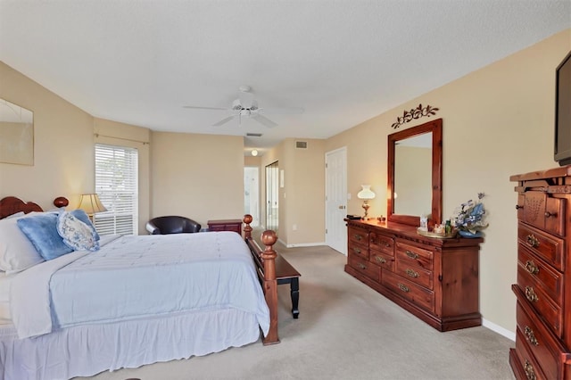 bedroom featuring light colored carpet and ceiling fan