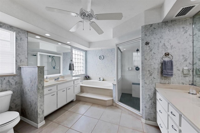 full bathroom featuring tile patterned flooring, toilet, vanity, ceiling fan, and independent shower and bath