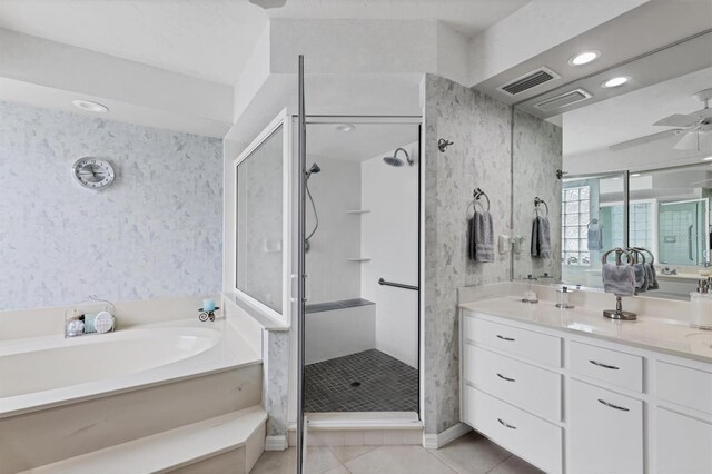 bathroom featuring plus walk in shower, vanity, tile patterned floors, and ceiling fan