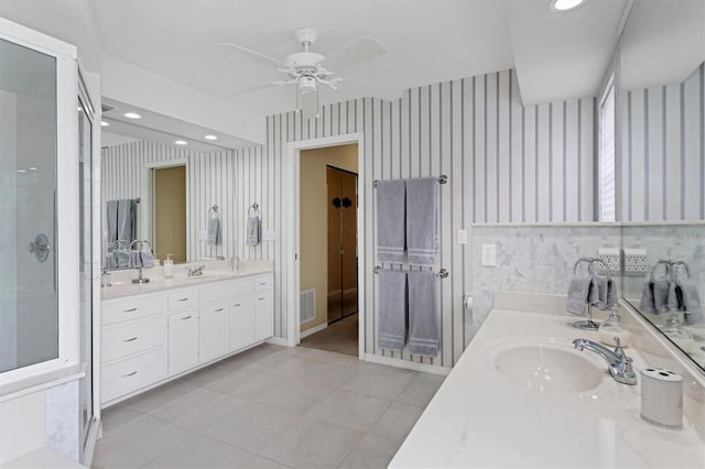 bathroom with vanity, ceiling fan, walk in shower, and tile patterned flooring