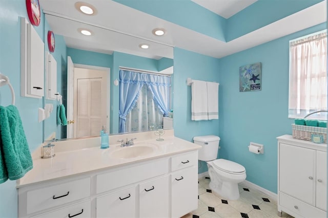 bathroom with tile patterned flooring, toilet, and vanity