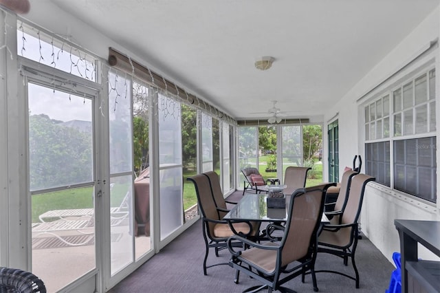 sunroom / solarium featuring ceiling fan, a mountain view, and plenty of natural light