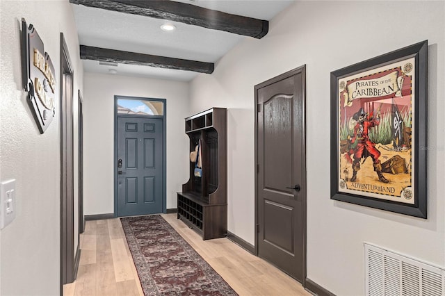 interior space with beam ceiling and light wood-type flooring