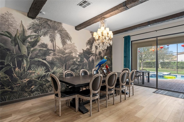 dining area featuring beamed ceiling, light hardwood / wood-style floors, a notable chandelier, and a textured ceiling