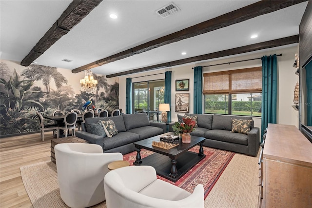 living room with beamed ceiling, french doors, light hardwood / wood-style flooring, and a wealth of natural light