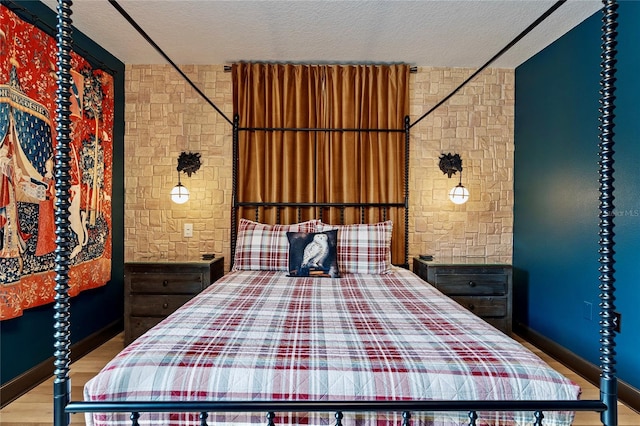 unfurnished bedroom featuring a textured ceiling and light wood-type flooring