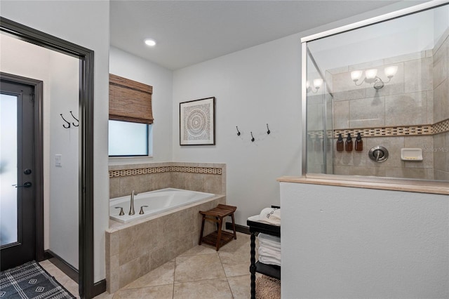 bathroom with plus walk in shower, tile patterned flooring, and a wealth of natural light