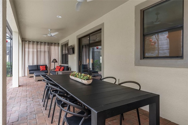 exterior space featuring outdoor lounge area and ceiling fan