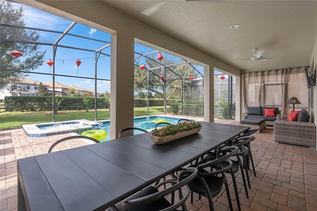 sunroom featuring ceiling fan