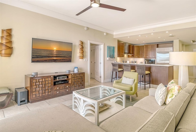 living room with crown molding, light tile patterned floors, and ceiling fan