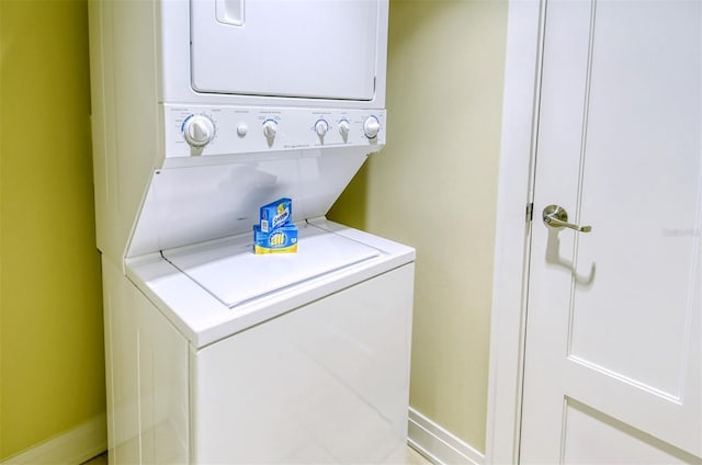 915 Seaside Drive 607, Weeks 14-15, Sarasota, FL 34242 - washroom with estacked washer and dryer and baseboards