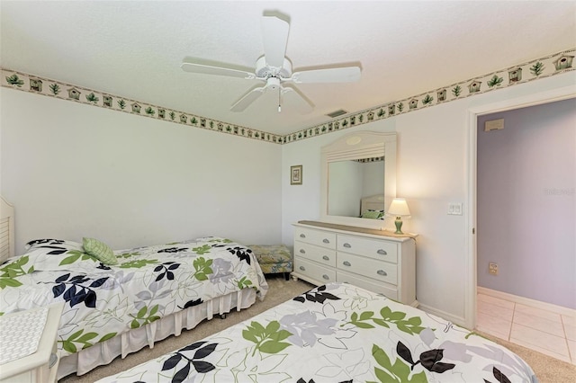 bedroom with tile patterned flooring and ceiling fan