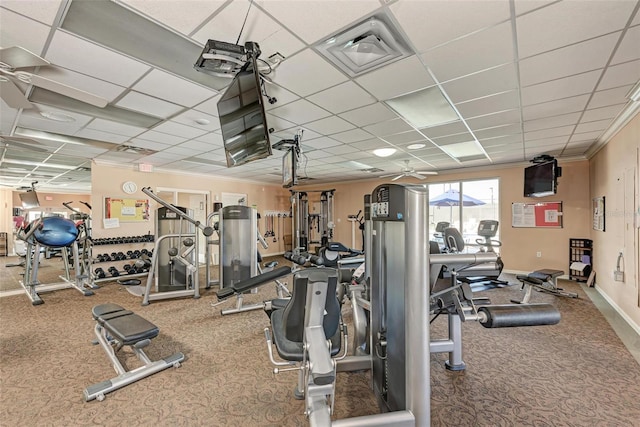 gym featuring crown molding, carpet floors, and a drop ceiling