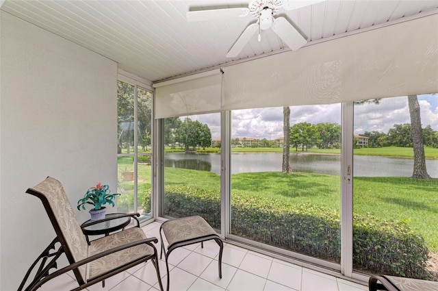 sunroom featuring a water view, a healthy amount of sunlight, and ceiling fan