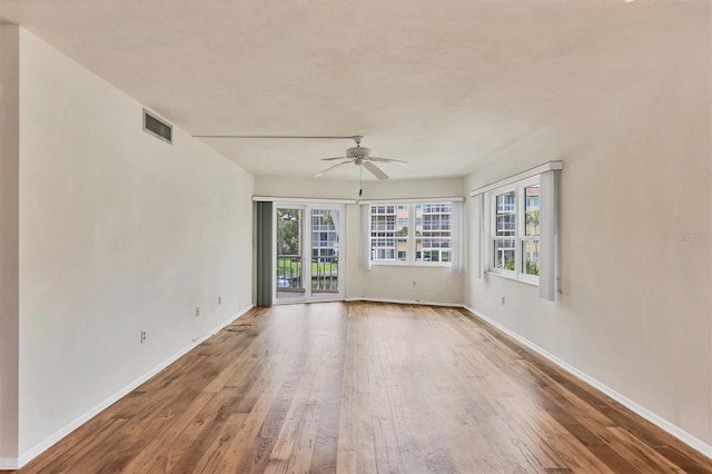 spare room featuring hardwood / wood-style floors and ceiling fan