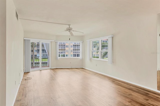 unfurnished room with hardwood / wood-style floors and ceiling fan