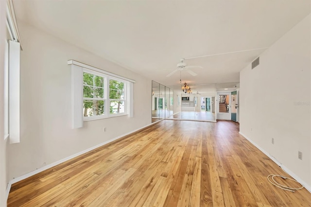 unfurnished living room featuring ceiling fan and light wood-type flooring